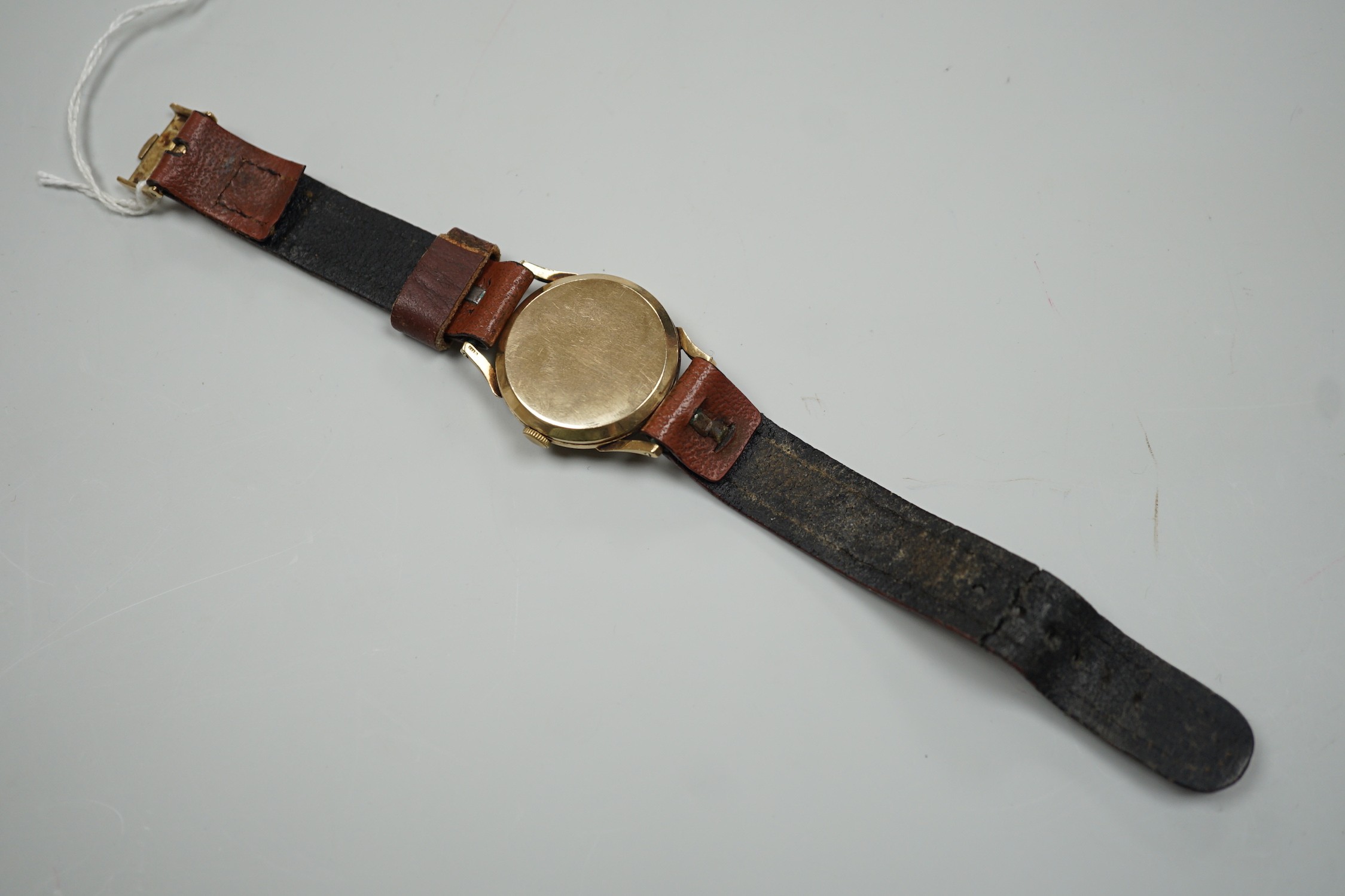 A gentleman's mid 1950's 9ct gold Rolex shock-resisting manual wind wrist watch, with baton and Arabic numerals and subsidiary seconds, on later associated leather strap, case diameter 32mm
